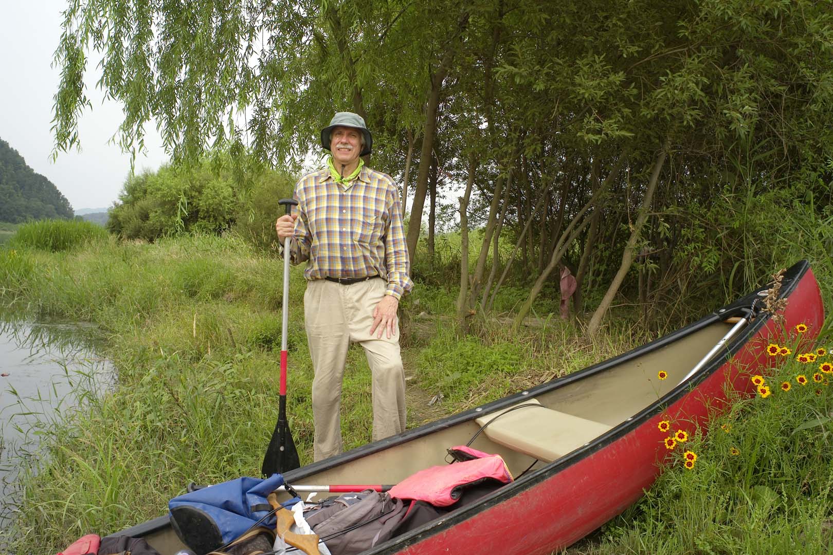 george standing next to boat