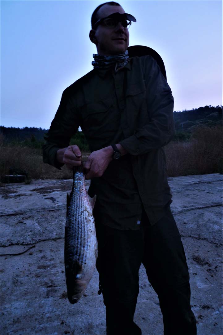 man holding caught fish